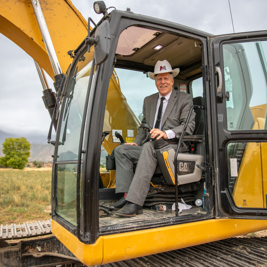 MTECH President in a tractor